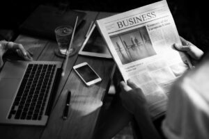 black and white desk image suggesting man reading about BT switch off