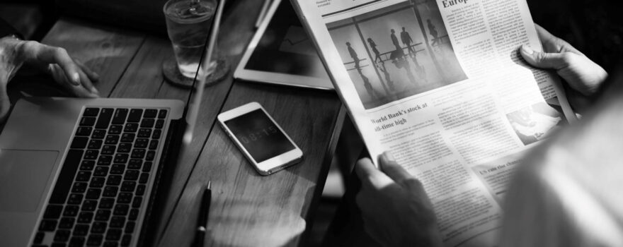 black and white desk image suggesting man reading about BT switch off